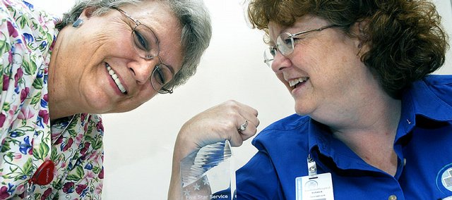 Emergency room nurse Marie Kettle, left, and medical records supervisor Susan Erikson pose with The Memorial Hospital's five-star 2006 Exceeding Patient Expectations award they received this week from Avatar International. Hospital officials said the staff - those who work one-on-one with customers - deserve the credit.