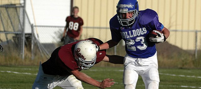 Craig Middle School running back Michael Samuelson stiff arms a Soroco defender Tuesday on his way to scoring a 76-yard touchdown. Samuelson accounted for all of the Bulldogs offense, scoring three touchdowns on the ground, as well as running for two, 2-point conversions, in CMS's 22-20 home victory.