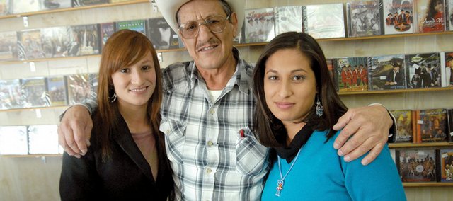 Eutiquio Pereyra, middle, owner of El Ranchero, poses for a photo with his nieces Jade Pereyra Payañ, left, 19, and Esmeralda Pereyra Payañ, 25, inside his store, which is located near a restaurant and goes by the same name. Jade and Esmeralda are in town, visiting their uncle from Chihuahua, Mexico. Pereyra said he's seen about 30 percent fewer customers during the past six months than he did last year.