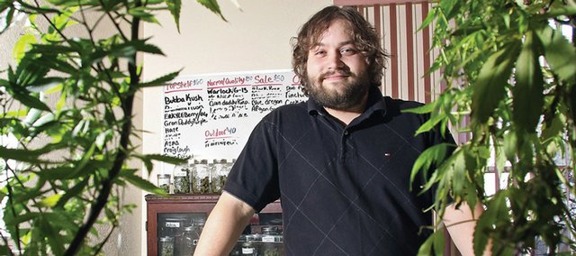 Craig Apothecary owner Shaun Hadley stands in front of a selection of medical marijuana Wednesday at his dispensary on Breeze Street. Hadley has seen business expand since opening Craig’s only medical marijuana dispensary in August 2009. Hadley said there’s been no crime reported at his business since opening.