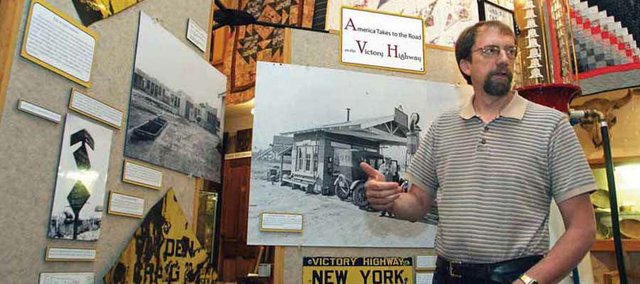 Dan Davidson, director of the Museum of Northwest Colorado, talks about the museum’s most recent exhibit, “America Takes to the Road on the Victory Highway,” Tuesday at the museum on Yampa Avenue. The exhibit showcases photos and signs along with a restored 10-foot manual gas pump used in the 1920s.