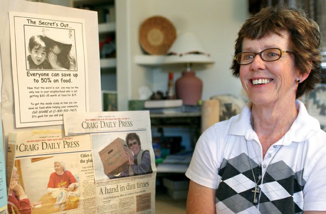 Karen Gibson, overall site coordinator for SHARE Craig, looks over a display board of newspaper clippings and fliers from the program’s 12-year tenure Monday at her home. SHARE Craig has disbanded following the bankruptcy of the organization that provided food for the program. Gibson said she’ll miss the connection with volunteers the most.