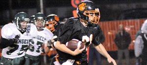 Hayden sophomore running back Ryan Domson runs from a pack of Rangely defenders Friday night. The Panthers suited up only 14 players for the game and started four freshmen. The Tigers took the advantage early, scoring 33 first-quarter points that led to a 47-14 victory.