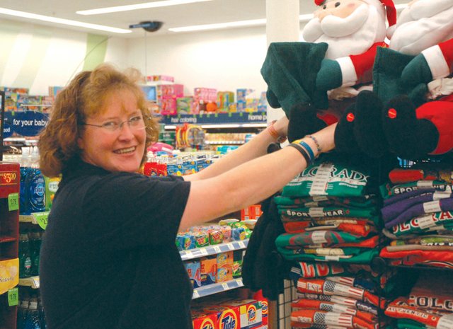 Walgreens service clerk Donna Aldridge positions a stuffed Santa Claus with the rest of the store’s holiday decorations. Aldridge has worked at Walgreens for two years. In her spare time, she likes to go mud-bogging, hunting and camping, playing pool with her family, and spending time with her numerous pets.