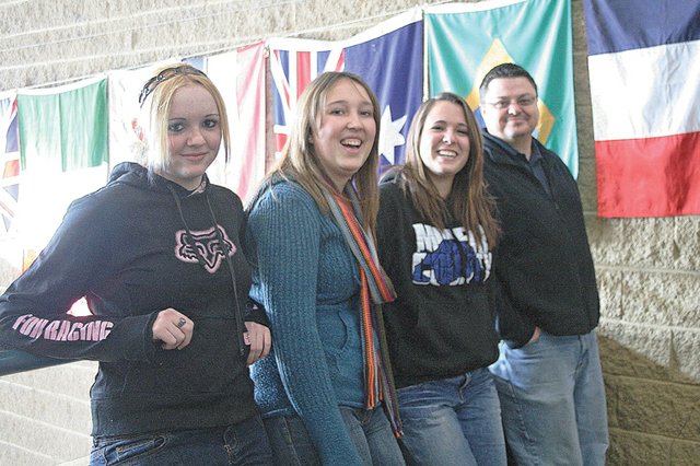 Travelers for an upcoming trip to Europe pose for a photo Friday at Moffat County High School. From 9 a.m. to 4 p.m. today, the school is hosting a craft show to raise money for the 10-day trip to France and Spain, which departs in March. Pictured, from left, are junior April Rogers, junior Kirstie McPherson, sophomore Faith Santistevan and teacher Jeff Simon. April Etheridge is not pictured.