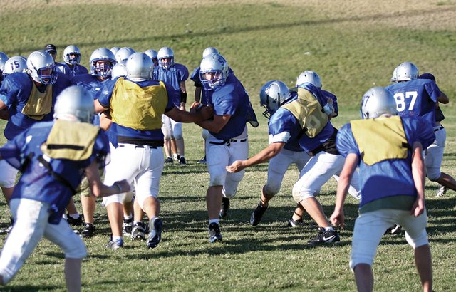 Hodge Raftopoulos runs through the line during offensive practice Wednesday at Moffat County High School. Raftopoulos, a senior, led the team in scoring last week out of the “thunder formation” against Delta High School and hopes he can repeat his three-touchdown performance tonight against Palisade High School.