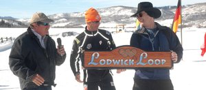 Lodwick Challenge organizers Johnny Fisher, left, and Erik Lunde present U.S. Nordic combined skier Todd Lodwick with a trail sign commemorating the Lodwick Loop at The Home Ranch in Clark on Sunday.