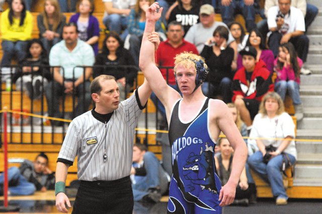 Charlie Griffiths, a Moffat County High School senior, has his hand raised after a victory in the 152-pound championship match Saturday in the 4A western regional tournament at Mesa State College. Griffiths will make his fourth trip to the 4A state meet and will be joined by fellow senior Cody Adams (189 pounds) and sophomore Garrett Stewart (135 pounds).