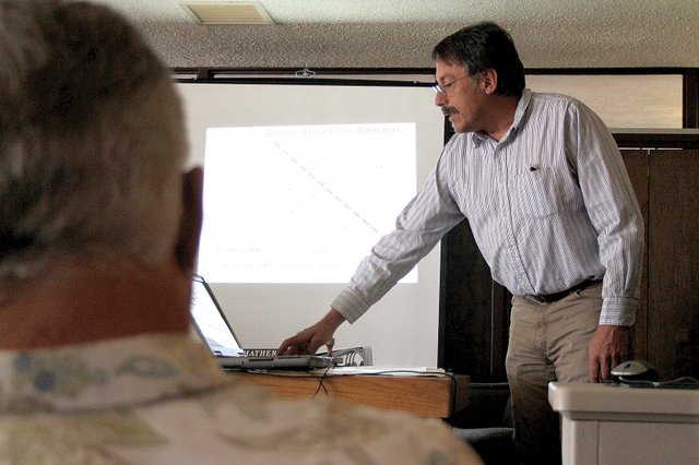 Peter Barkmann, right, a geologist with the Colorado Geological Survey, presents information Tuesday to the Moffat County Commission about a current project being conducted to study carbon sequestration in the area. Barkmann said the CGS will drill a test well in August to take core rock samples from about 9,600-feet underground to study whether carbon emissions from power plants could be sequestered south of the Craig Station power plant.