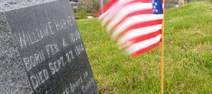 The Stars and Stripes whip in the wind in front of the grave of William E. Harvey, a Civil War veteran buried in Steamboat Springs Cemetery. Kentucky librarians say evidence indicates William E. Harvey was not a Confederate soldier and likely fought for the Union.