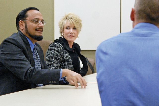Rural Physicians Group associates Sukhbir Pannu, left, and Cindy Johnson discuss Thursday the benefits of their hospitalists program to The Memorial Hospital Board. The company could provide TMH with up to four internists who would live at the hospital on a rotational basis, 24-hours a day, for stretches of up to 10 days.