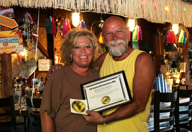 Teri, left, and Danny Griffith, owners of J.W. Snack’s Bar & Grill, smile Thursday with the Chamber Select award presented to the restaurant. The Craig Chamber of Commerce Board selected the restaurant as the first recipient of the award for customer service, food quality, cleanliness and community involvement. The Chamber welcomes community nominations for future Chamber Select recipients.