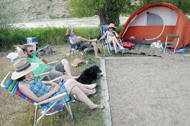 Four friends relax Saturday at South Beach after canoeing the Yampa River from Hayden. The group traveled from the Front Range to paddle and camp in Northwest Colorado. Camping and boating in Moffat County has finally hit its stride after a long winter and spring. Shown, clockwise from left, are Boulder residents Lindsey Gano and Neil Gano, and Brighton residents Charlie Worley and Jessica Worley.