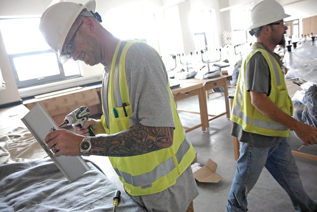 Central Electric employee Dale Morris, left, installs equipment Friday at the new Colorado Northwestern Community College campus in Craig. The school will host a ribbon-cutting ceremony at noon Aug. 8 at the new academic building, 2801 W. Ninth St. The event will include guided tours of the new facilities.