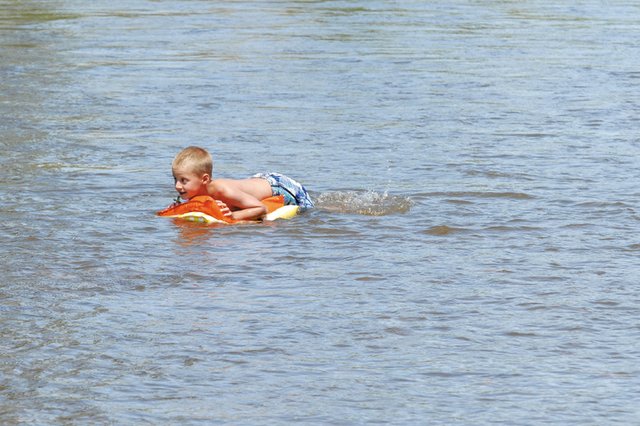 Caden Call, 7, floats Friday in the Yampa River off Pebble Beach while enjoying time with his friends and family. The river’s water levels have gone down considerably since reaching dangerous numbers in May. However, flow is still well above average, and officials warn recreational users to be extremely cautious.