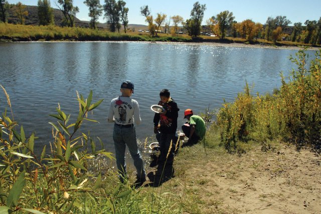 Sambu Shrestha, center, a Sunset Elementary School fifth-grader, examines his find Thursday afternoon at Yampa River State Park. He and other Sunset and East elementary school fifth-graders panned for gold on the Yampa River, one of several activities offered during a two-day science camp Thursday and Friday designed to teach students hands-on lessons about nature and the environment.