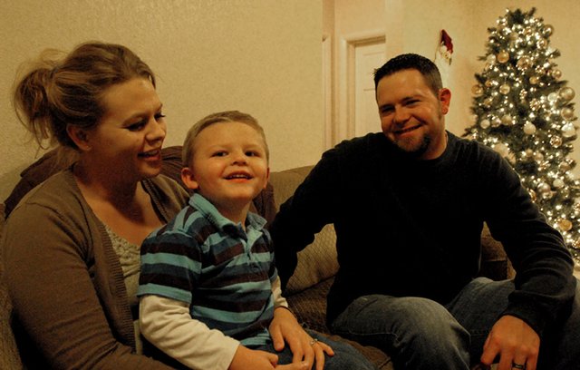 Megan, Kelton and Steve Mudge sit inside their home in Craig. When Kelton was born, Megan and Steve were told their son would live in a vegetative state because of complications he endured while in the womb. But, Kelton proved them wrong: he recently graduated from Horizons Specialized Services’ Early Intervention program, where he learned basic motor and communication skills.