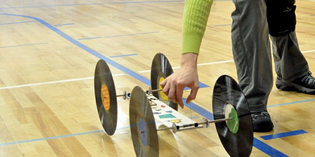 Sandy Sorensen, Craig Middle School seventh- and eighth-grade science teacher, examines eighth-grader Ian Day’s mousetrap car Tuesday morning during the school’s annual mousetrap car rally in the CMS gym. The event was part of a physics unit that included lessons about simple machines, like levers, wheels and axles.