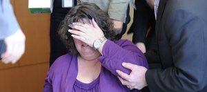Shooting victim Rhonda Heaton was overcome with emotion Thursday after a jury convicted her former husband Robert Cash of attempting to murder her. Consoling Heaton at the Routt County Justice Center is Routt County Chief Deputy District Attorney Rusty Prindle.