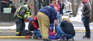 Steamboat Springs Fire Rescue emergency responders aid a 53-year-old Texas woman after a car struck her just after 11 a.m. Saturday at Fifth Street and Lincoln Avenue.