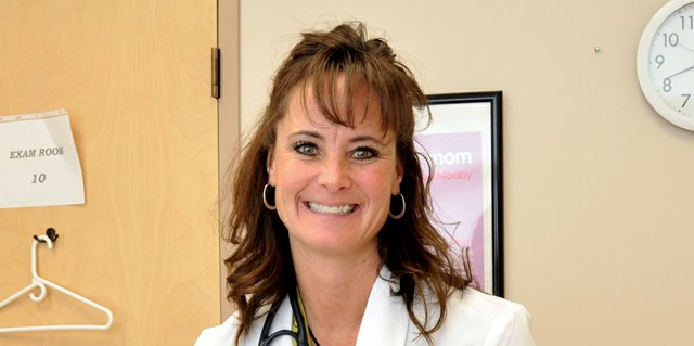 Terri Jourgensen, a triage nurse and clinical specialist for the Northwest Colorado Community Health Center, holds a photo album, a parting gift from the Moffat County School District, where she worked as a district nurse for a decade. Jourgensen left the school district recently and looks back on her career there with fondness.