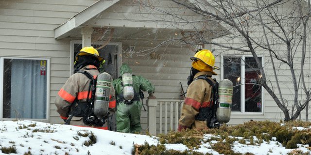 Craig Fire/Rescue firefighters and members of the Moffat County Hazmat Team prepare Friday to enter a home at 826 Colorado St., a vacant residence believed to contain the remnants of a dormant methamphetamine lab. “At this point, we have no idea who was responsible” for creating the lab, said Marvin Cameron, All Crimes Enforcement Team commander.