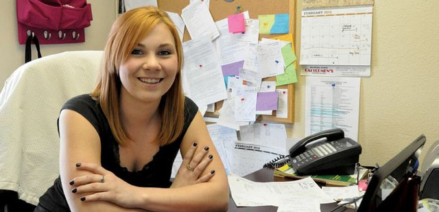 Dorina Fredrickson, 20, pauses from her busy schedule Tuesday in her office at Country Living Realty, where she is a receptionist. Fredrickson, a 2009 Moffat County High School graduate, also is a full-time student at Colorado Northwestern Community College, where she plans to graduate with her associate’s degree in liberal arts in May 2013.