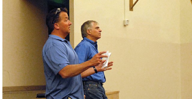 Mark Samuelson, left, and Tony Peroulis talk to Moffat County Booster Club members Wednesday in the Moffat County High School auditorium. Samuelson, the club’s vice president, and Peroulis, the club’s president, said the mission of the club is to help financially support extracurricular activities at MCHS and Craig Middle School.