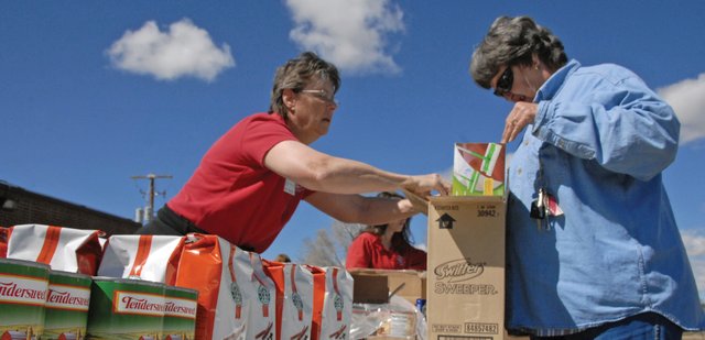 Becki Miller, left, a volunteer and front desk administrator for the Boys & Girls Club of Craig, helps disburse food during the Food Bank of the Rockies’ first mobile food pantry distribution in Craig. Starlene Collins, Western Slope Manager for FBR, said the agency plans on having a mobile food pantry distribution every month at the Boys & Girls Club of Craig, 1324 E. Highway 40.