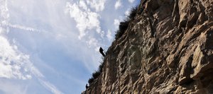 Carson Bartsch, top, rappels down a cliff with Matt Dossett on Tuesday in Mount Harris Canyon to start rock scaling operations above U.S. Highway 40. After loose rocks are removed, crews will install netting and fencing on the cliff for the first time to prevent rockfall.