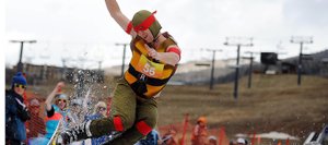Carter Allen kicks off the end of the pool at Sunday’s Splashdown Pond Skim at Steamboat Ski Area.