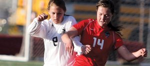 Steamboat's Sara Stout, right, tackles the ball away from Battle Mountain's Rosie Davis during a game Tuesday at Battle Mountain in Edwards. Battle Mountain won the game, 3-0.