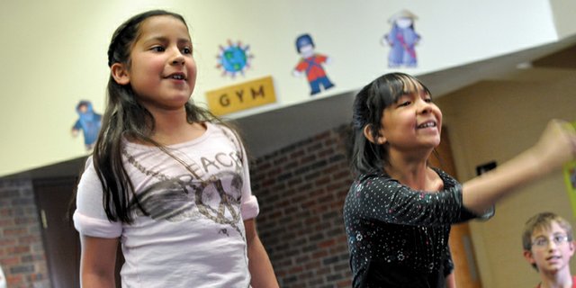 Sunset Elementary School third-graders Alexei Reyes, left, and Guadalupe Loya compete in a sprinting event on an Xbox Kinect on Tuesday at the school. Sunset Elementary classes are vying for the best scores in five sporting events during Sunset Olympics, a two-week project designed to spark children’s interest in the 2012 Olympic games.