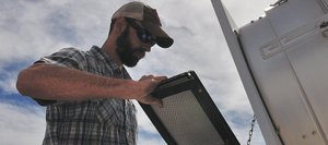 Routt County Environmental Health specialist Jason Striker changes out the filter of an air quality monitor Thursday on top of the Routt County Courthouse in downtown Steamboat Springs. County commissioners are planning to add sensors on the roof and in western Routt County capable of detecting oil and gas emissions.