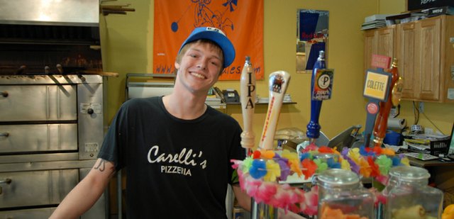 Kyle Perez leans on the counter at Carelli’s Pizzeria & Pasta during a short break in between customers. Perez, 19, makes sandwiches for the restaurant and also works as a night shift manager. He is also an avid skateboarder in his spare time. His mother, Stephanie, and her fiancé, Brett Etzler, bought the business in December 2010.