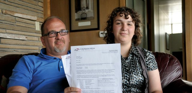 Kaitlen Bird, 18, and her father, Joe Bird, look over her acceptance letters from Colorado Mesa University and its music department in their Craig home. In light of decreasing employment rates for recent college graduates, Bird said he hopes he can help Kaitlen avoid taking out loans to pay for her education.