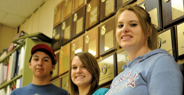 From left, Brady Martinez, Emily Wellman and Makayla Goodnow, members of the Moffat County High School Future Farmers of America meat judging team, pose for a photo Tuesday at the high school’s agricultural shop. Their team, which included MCHS junior Tyler Hildebrandt, took the state title in meat judging during an FFA event April 30 in Fort Collins.