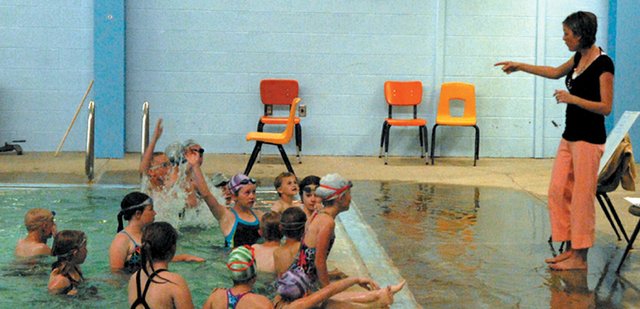 Meghan Francone teaches Craig Sea Sharks members the correct stroke techniques at the shallow end of the Moffat County High School pool. The Sea Sharks team, which is still accepting applicants, will begin practicing Tuesday at the Craig Swimming Complex and will swim in the first competition of the season Friday and Saturday in Rangely.