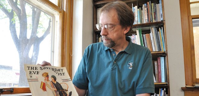 Dan Davidson, Museum of Northwest Colorado director, holds an original Saturday Evening Post cover featuring the “Spirit of Education” on Tuesday in his office. The museum is exhibiting the original painting by Norman Rockwell, as well as all 323 Saturday Evening Post front-page tear sheets featuring Rockwell’s work, but Davidson was able to purchase this magazine cover online and plans to keep it at the museum after the exhibit ends in September. “I guess it’s going to be our memento,” he said.