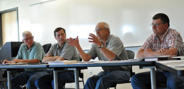 Rick Johnson, second from right, Colorado Northwestern Community College Board member, speaks during a special meeting Thursday about a proposed land transfer to the Craig Rural Fire Protection District for a fire training facility. The motion died for a lack of a second after about 15 community members voiced opposition to the proposed transfer.
