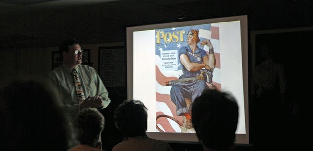 Tom Daly, left, Norman Rockwell Museum curator of education, discusses an illustration Norman Rockwell painted for The Saturday Evening Post during a presentation Saturday morning at the Museum of Northwest Colorado. Daly pointed out similarities between the illustration and Michelangelo’s painting of the prophet Isaiah in the Sistine Chapel to illustrate how Rockwell took inspiration from great artists of the past.