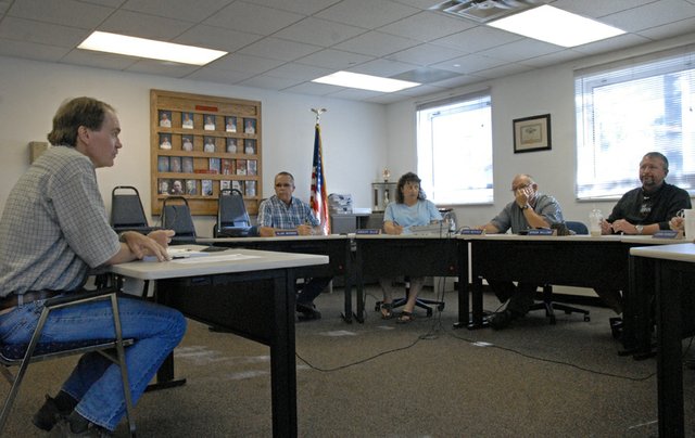 Todd Ficken, left, of Niwot-based F&D International, LLC, an architectural and engineering firm, presents to the Craig Rural Fire Protection District Board a $470,529 contract with WHP Trainingtowers for the purchase of a fire training tower kit. The board approved the contract, 4-0, and is seeking to finish the tower before the end of the year.