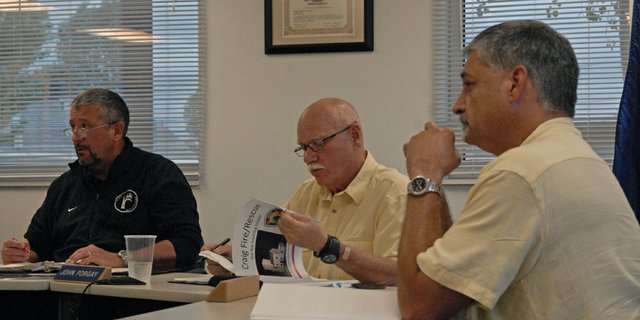John Forgay, center, Craig Rural Fire Protection District Board member, reviews a hard copy version of the fire district’s presentation on a live fire training tower proposed for construction in Craig. The power point presentation has been updated to reflect the board’s plans at its alternate location on Industrial Avenue behind Kmart. It will soon be available for public view by visiting www.craigfirerescue.org.