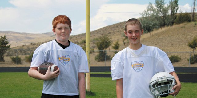 Justin Dugan (left) and Cole White attended the USA Football Academy to help prepare for their first season of 11-man football as seventh graders at Craig Middle School. Dugan and White said the camp improved their respective games and has given them a leg up on competition before the CMS season starts.