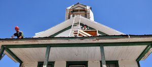 Rocky Mountain Youth Corps volunteers Kris Gayer, left, and Austin Bail work on the roof of the Foidel Canyon Schoolhouse on Monday afternoon. Historic Routt County is leading the effort to restore the structure that sits near Twentymile Coal Mine.