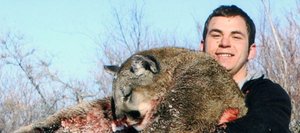 Michael Miklavicic holds a mountain lion he shot during a hunting trip last winter.