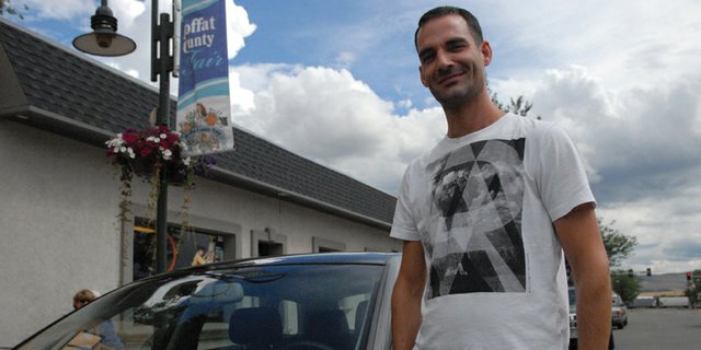 Joshua Green stands with his car adorned with a placard for the FX series, “Justified,” for which he works as a set decoration buyer. The creative team, including Green, was among the nominees for the 64th annual Primetime Emmy Awards, shortlisted for Outstanding Art Direction for a Single-Camera Series. Green grew up in Craig and graduated from Moffat County High School in 1998.