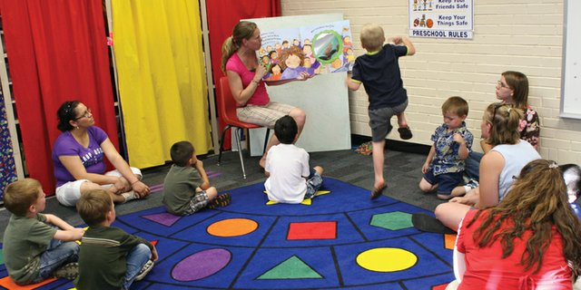 Preschool teacher Heather Higgins reads a story to preschool students and parents during the Moffat County School District’s extended-year program June 26 at the district’s Early Childhood Center. Connections 4 Kids, the early childhood council serving Moffat and Rio Blanco counties, recently released its 2011-12 Annual Report, which included details about the council’s professional development projects for early childhood providers. The rug and book pictured above were part of the Early Childhood Center’s grant application.