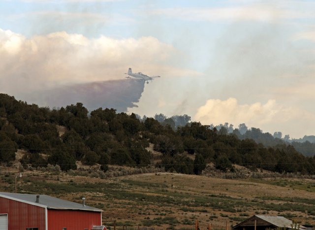 A single-engine air tanker drops fire retardant Wednesday on the Sugar Fire, a wildfire that burned five acres of Bureau of Land Management land about 20 miles west of Craig. The Sugar Fire was ignited by a lightning strike about 3:15 p.m. Wednesday. It was reportedly contained at 10:45 a.m. Thursday.