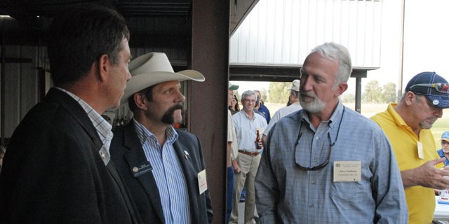 Jerry Nettleton, right, environmental manager at Twentymile Mine, chats Tuesday with state representatives Jerry Sonnenberg, left, and Randy Baumgardner, center, during the Colorado Coal & Power Generation Conference barbecue at Loudy-Simpson Park. On Tuesday morning Nettleton updated more than 70 people attending the conference about Twentymile’s future expansion into the Sage Creek reserve.